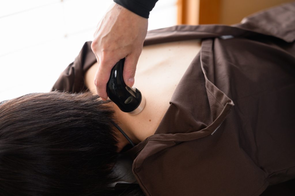 沼津市の接骨院で背中に超音波治療を受ける女性